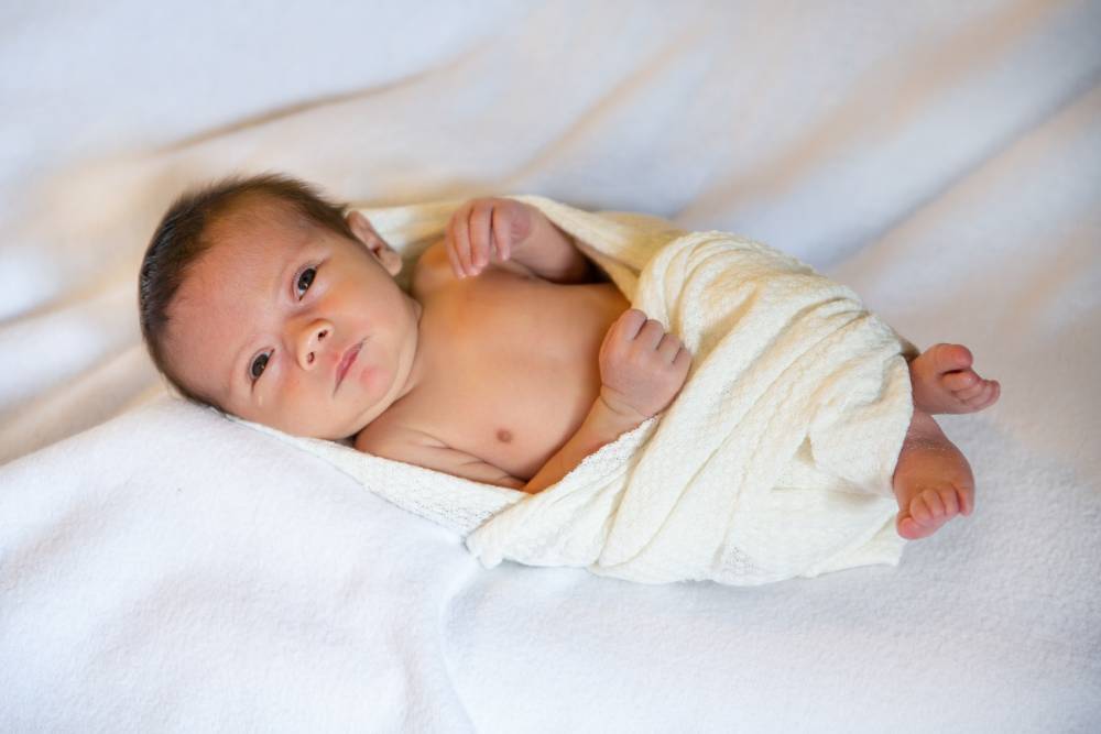 Asian baby wipes with a towel after a bath